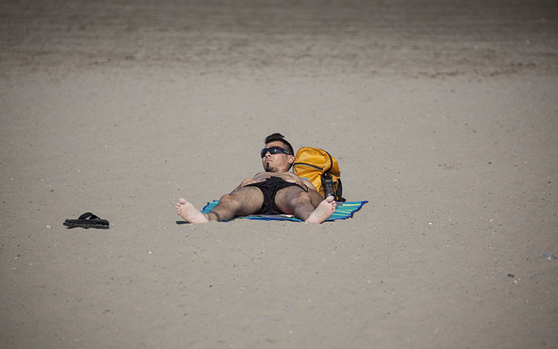 Guy laying on the beach