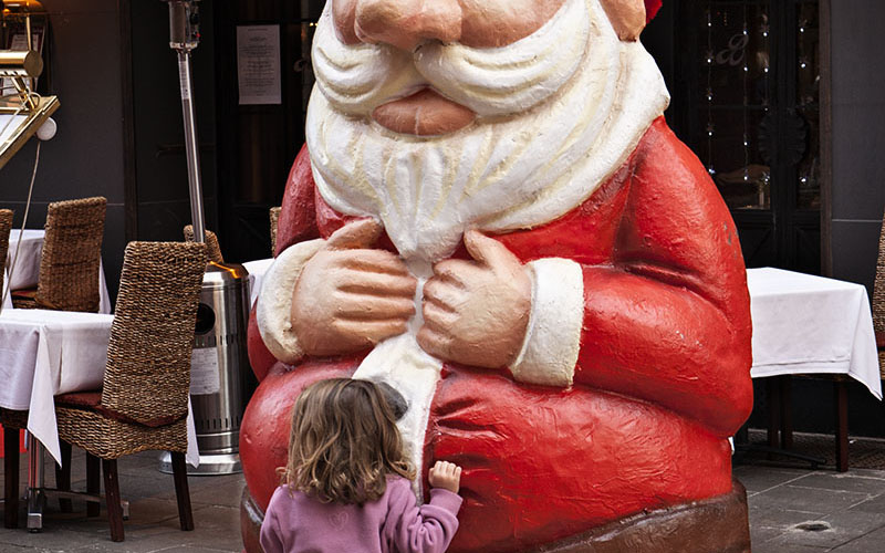 Little girl with plastic santa